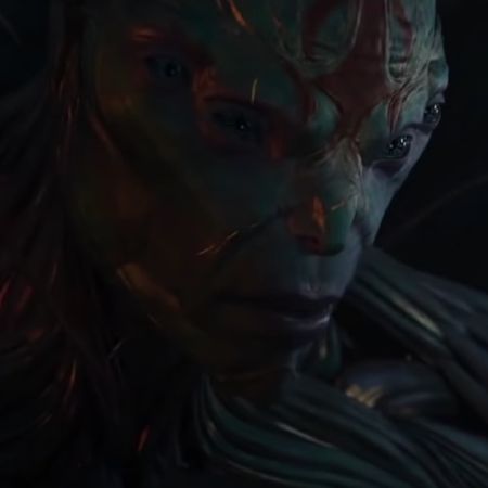 Kro has grey skin and four eyes in the picture.